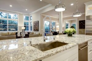Beige granite countertop facing spacious living room 
