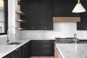 Kitchen with black cabinets and stainless steel appliances