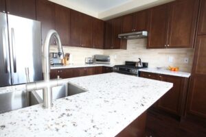 Kitchen with white quartz countertops and dark wood cabinets